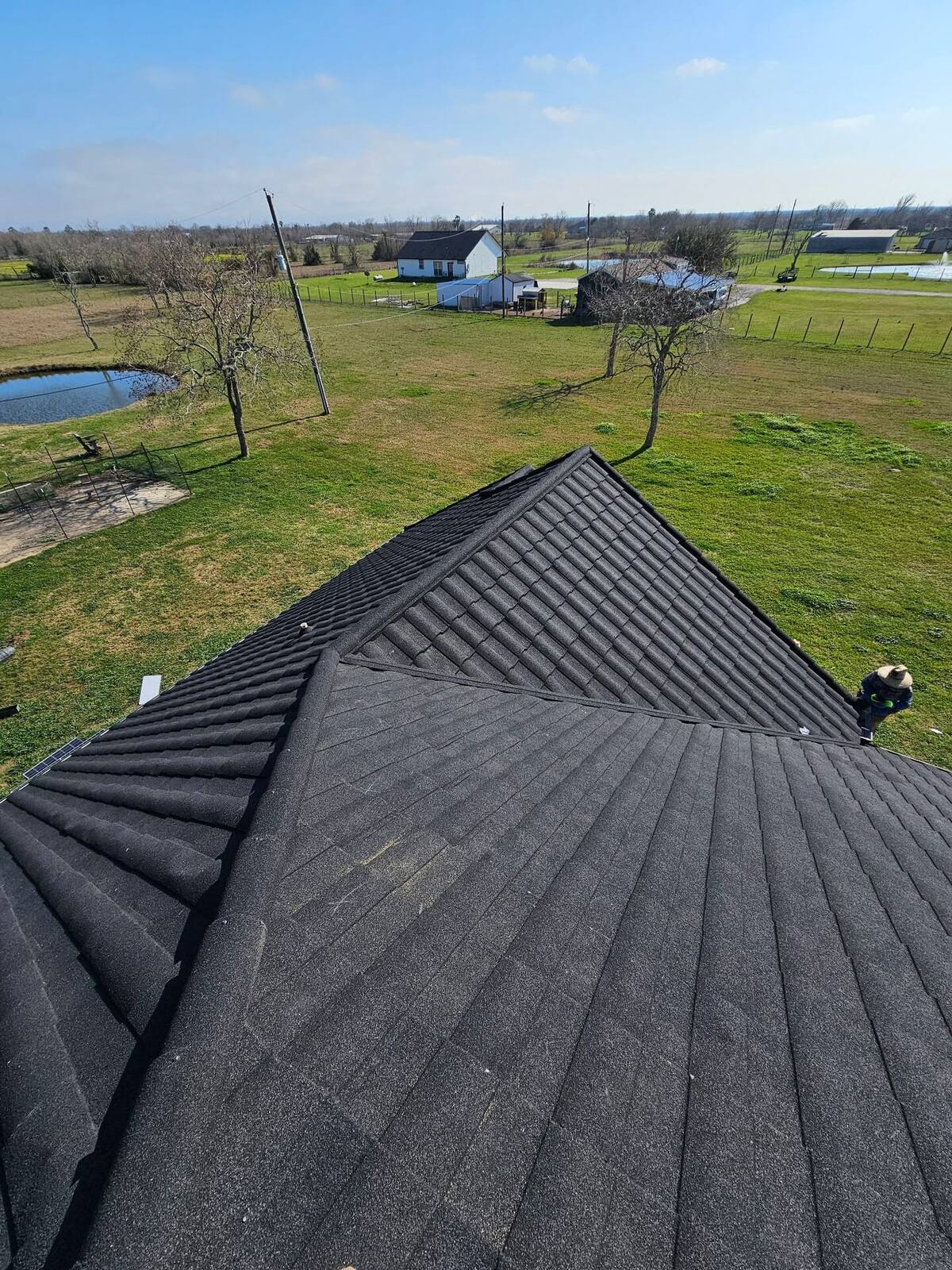 Emergency tarping on a commercial roof after storm damage